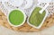 Homemade green tea (kelp, algae, spirulina) face or hair mask (scrub) in a small white bowl and matcha powder.