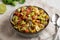 Homemade Grilled Corn Summer Pasta Salad in a Bowl on a white wooden background, low angle view