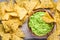 Homemade guacamole with corn chips top view