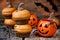 Homemade Halloween pumpkin cupcakes on dark wooden background for trick or treat night. Festive Halloween party background