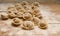 Homemade handmade dumplings in flour on wooden background