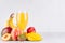 Homemade healthy beverage - multi fruits juice of red, yellow, green, orange fruits on soft light white wood background.