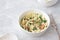 Homemade healthy cole slow salad with kale in white bowl on gray textured background