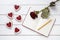 Homemade heart shaped cookies with empty notebook frame, pencil and red rose gift composition for Valentines Day