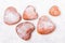 Homemade heart sheped donuts with powdered sugar on white background.