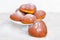 Homemade heart sheped donuts with powdered sugar on white background.