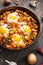Homemade Hearty Breakfast Skillet with Eggs Potatoes and minced meat on wooden table