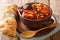 Homemade hearty Callos made from tripe, chorizo, blood sausage and chickpeas in a spicy gravy close-up in a bowl. horizontal
