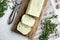 Homemade Herb Butter with garlic, on white stone  background