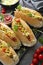 Homemade hot dog sandwiches. Hot dogs with mustard and letuce toping on a dark background