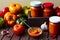 Homemade hot tomato sauce adjika in jars - Tomatoes, chilli pepper, garlic, herbs on wooden table.