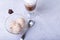 Homemade ice cream with chocolate chips in a bowl. Three balls of ice cream and a cup with coffee.