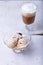 Homemade ice cream with chocolate chips in a bowl. Three balls of ice cream and a cup with coffee.