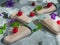 Homemade ice cream of fruit and cream on decorative sticks is on a light background. The composition is decorated with pieces of