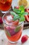 Homemade iced tea with strawberries and mint, vertical, closeup