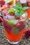 Homemade iced tea with strawberries and mint, vertical closeup