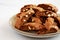 Homemade Italian Cantuccini with Almond and Coffee on a Plate on a gray surface, side view. Crispy Almond and Coffee Cookies