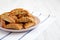 Homemade Italian Cantuccini with Pistachios and Citron on a Plate, side view. Crispy Pistachio and Citron Cookies. Copy space