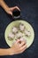 Homemade khinkali dumplings and glass of wine on the stone rustic table. Female hands