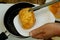 Homemade kitchen. Croutons or toasts of white bread, soaked in a beaten chicken egg, are fried in frying pan for frying on a small