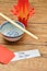 A homemade lantern display with a pair of chopsticks, a bowl and a red envelope with a note Happy New Year