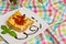 Homemade lasagna on white plate and colorful tablecloth