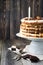 Homemade layered pastry cake and meringue, walnuts, dark chocolate on old wooden background. Selective focus