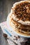 Homemade layered pastry cake and meringue, walnuts, dark chocolate on old wooden background. Selective focus