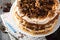 Homemade layered pastry cake and meringue, walnuts, dark chocolate on old wooden background. Selective focus