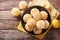 Homemade lemon muffins sprinkled with zest close-up on a plate.