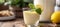 Homemade lemon posset in a glass, adorned with a mint leaf and lemon slice, rustic charm
