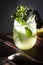 Homemade lemonade with fresh mint leaves at sunset. Moody photography of drink.