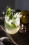 Homemade lemonade with fresh mint leaves at sunset. Moody photography of drink.