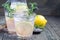 Homemade lemonade with lavender, fresh lemons and rosemary on wooden table, horizontal, copy space