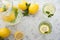 Homemade lemonade on a light background concept. Lemons, glasses, mint, jug and copy space. Summer refreshing drink lemonade