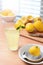 Homemade Lemonade still life. A glass of fresh squeezed lemonade on a kitchen table with strong sunlight streaming through the