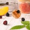 Homemade lollipops made from natural dehydrated peach and blackberries on a white wooden background. Healthy vegan vegetarian food