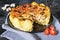 Homemade Lorraine pie with potatoes, chicken, mushrooms, cheese, onions and seasonings.