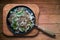 Homemade lunch. Beef steaks on the iron plate. Isolated on wooden background.Copy space