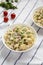 Homemade Macaroni Salad in white bowls, side view