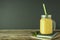 Homemade mango, lemon ice-cream or milk shake in mason jar cups, rustic wooden background. Vintage style. Copy space