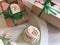 Homemade marshmallows packed in crafting boxes and tied with a green ribbon with a bow. Next on the table are separate portions of