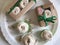 Homemade marshmallows packed in crafting boxes and tied with a green ribbon with a bow. Next on the table are separate portions of