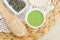 Homemade matcha green tea (kelp, algae, spirulina) face or hair mask (scrub) in a small white bowl