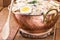 Homemade mayonnaise with vegetables, eggs, tomatoes and fruits, typical Brazilian food, served in copper pot, isolated on rustic