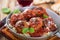 Homemade meatball with Italian pasta in frying pan on rustic wo