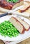 Homemade meatloaf garnished with green peas