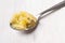 Homemade melted butter on a spoon. Ghee. Ayurveda. On a white background