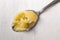 Homemade melted butter on a spoon. Ghee. Ayurveda. On a white background