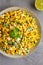 Homemade Mexican Street Corn Esquites on a Plate on a gray background, top view. Flat lay, overhead, from above. Close-up